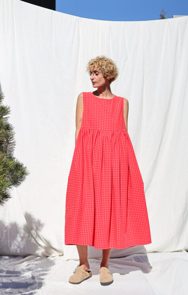 Sleeveless smock dress in glace cherry red seersucker checks | Dress | Sustainable clothing | OffOn clothing